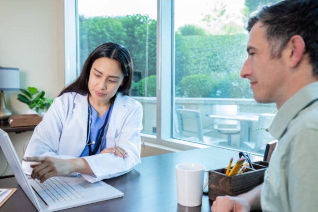 Women doctor explaning tail coverage to her patient.