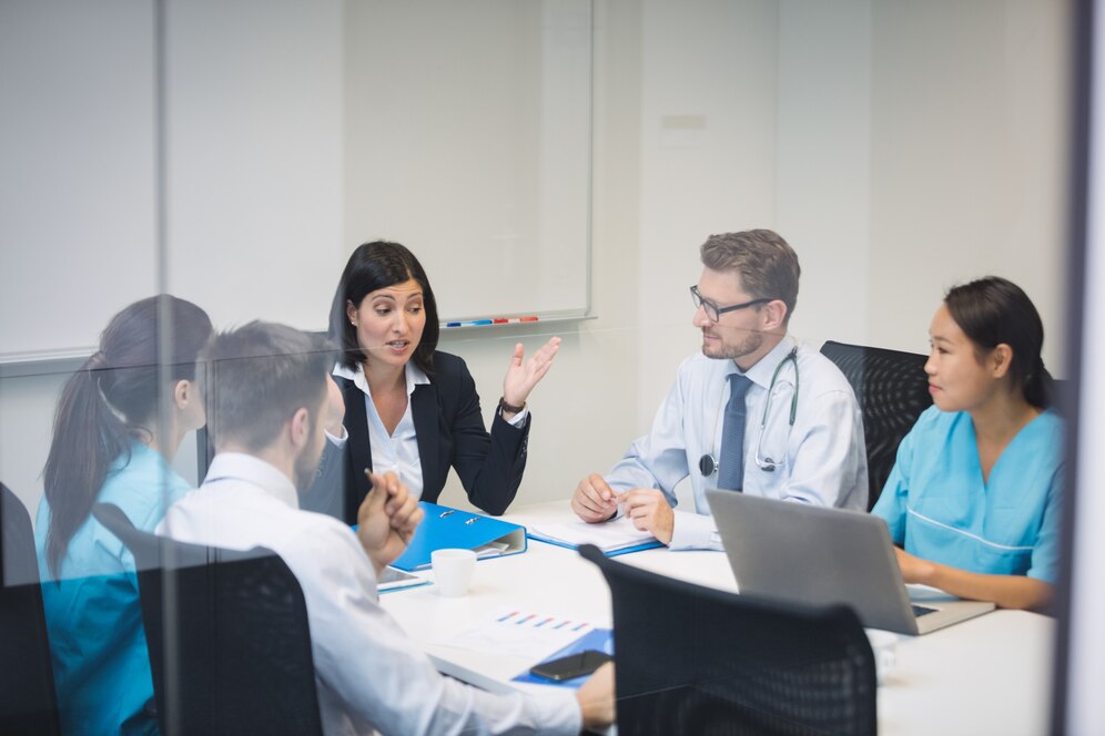 Insurance agent discussing with doctors regarding professional liability insurance