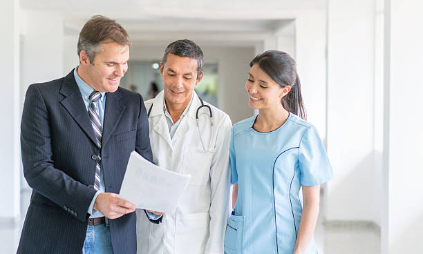 Doctors discussing with medical malpractice insurance agent