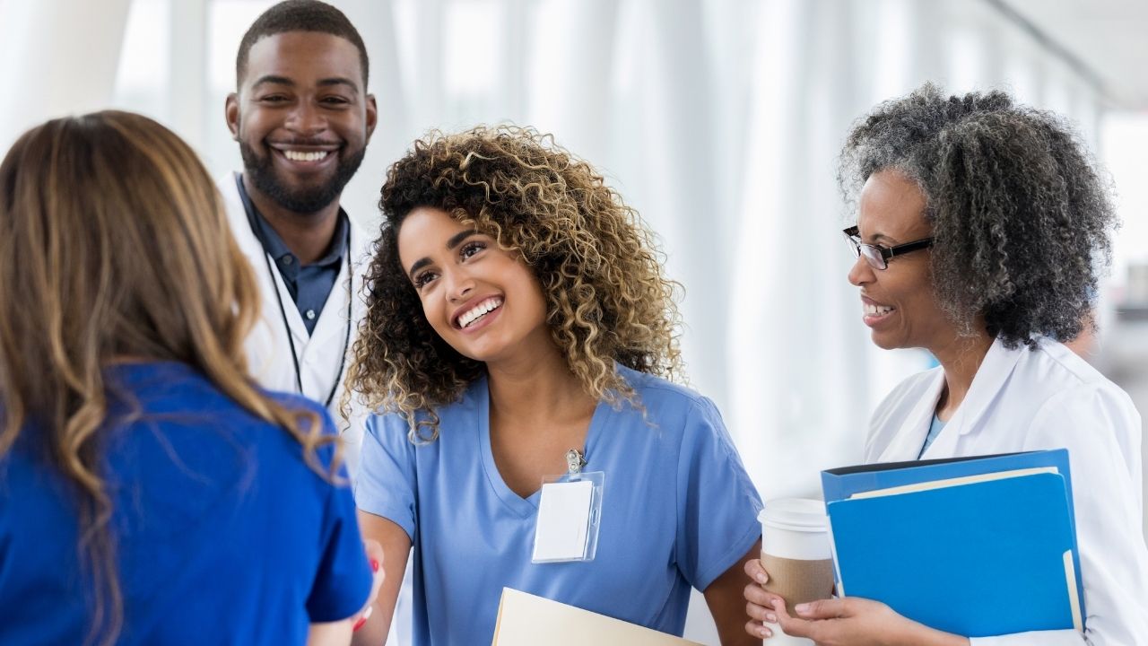 Physicians congratulating a colleague on career transitions