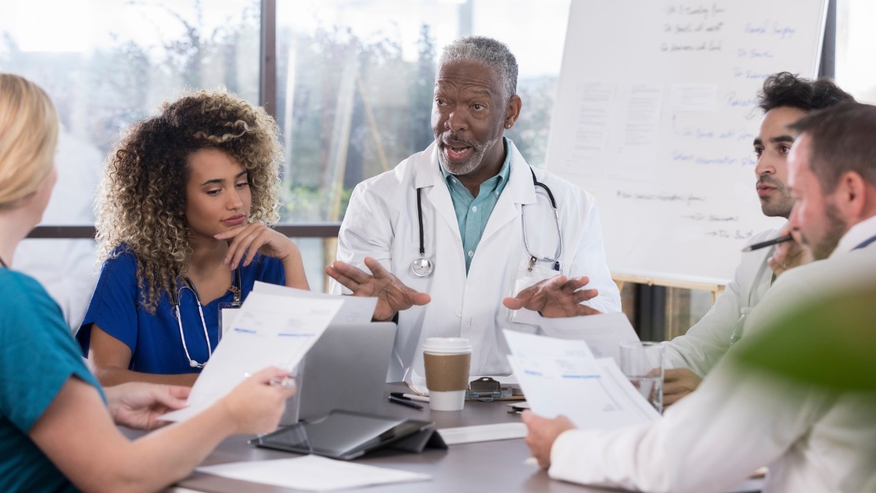 Doctors discussing claims made and occurrence polices for their medical group