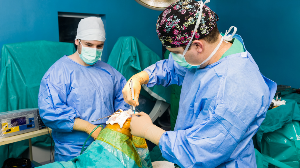 Cardiologists performing a surgical cardiac procedure in a sterile operating room.
