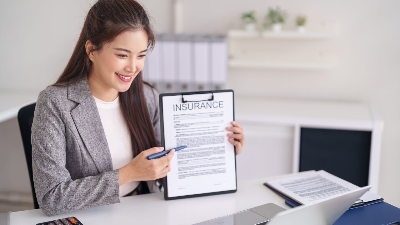 Insurance agent reviewing a malpractice policy with a physician