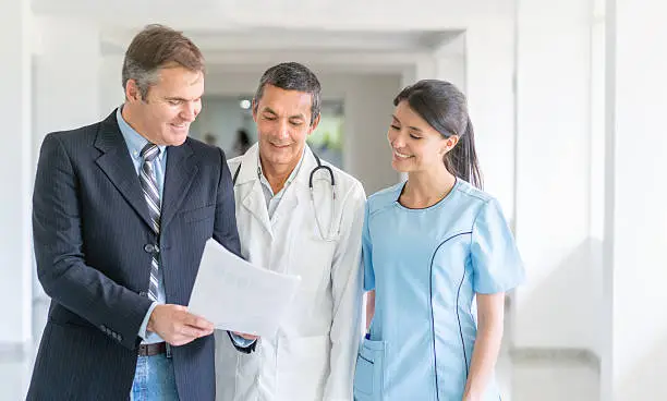 Doctors discussing with medical malpractice insurance agent
