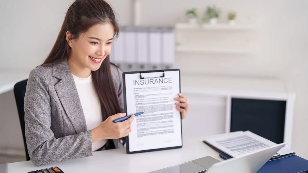Insurance agent reviewing a malpractice policy with a physician